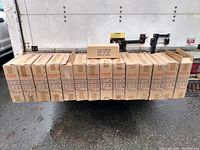 Multiple cardboard boxes arranged in a row, showing box labels and packaging conditions with fragile markings and shipping details.