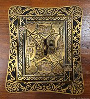 Top view of the removable lid featuring the King of Hearts playing card design with gold and black ornate detailing and a central handle.