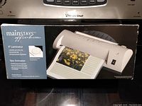 Photo of the laminator box showing the Mainstays brand and model details.