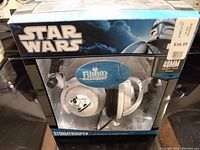 Front view of boxed Star Wars Stormtrooper DJ Stereo Headphones by Funko, showing branding, Stormtrooper helmet design on ear cups, and 40mm driver size sticker.