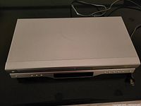 Complete front and top view of the Toshiba SD-V393 DVD and VHS combo player, showing clean silver unit with top DVD tray and front VHS slot.