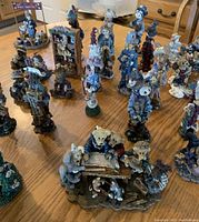 Photo showing 20+ Boyd's Bear figurines on a wooden table with detailed outfits and group scenes