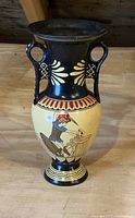Full side view of ceramic vase showing ancient warrior design.