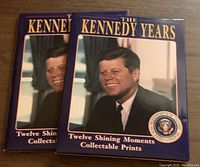 Two copies of 'The Kennedy Years Twelve Shining Moments Collectable Prints' featuring JFK cover image.