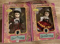 Two boxed collectible dolls labeled Scotland and France in traditional attire from the New Bright Collection.