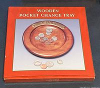 Photo of boxed wooden pocket change tray showing product and packaging.