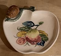Ceramic peach-shaped dish featuring hand-painted peaches, leaves, berries and a raised ladybug decoration on the rim.