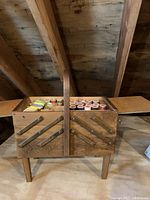 Closed wooden sewing box showing exterior and handle.