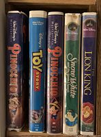 Photo showing Disney VHS tapes including Pinocchio, Toy Story, Snow White, and The Lion King.
