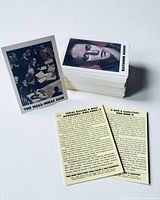 Stack of trading cards including 'The Hall-Mills Case' card and 'Raymond Morris' card front and back shown.