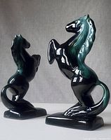 Front and side view of the pair of rearing Blue Mountain Pottery horses, showing glossy ceramic finish and color detail.