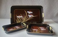 Three retro flower trays arranged with design and handles visible for size comparison.