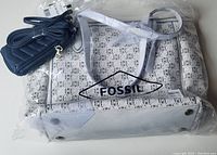 Photos show the brand new Fossil Skylar large tote and crossbody bags in beige with neutral floral pattern and light beige leather trim, packed with tissue paper, plus the small navy Van Heusen quilted phone and wallet bag with strap.