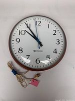 Full front view of Edwards brand wall clock showing entire face, hands, and power cord.