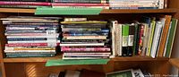 Books arranged on wooden shelves with labels and various titles on art and gardening techniques.