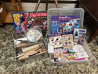 Overview of clay craft books, assorted polymer clay blocks, plastic and metal tool sets displayed on carpet
