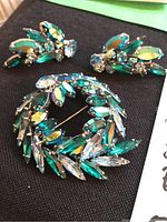 Brooch and pair of earrings on black cloth background