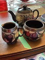 Teapot, creamer and sugar bowl grouped on table showing overall lot