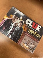 Harry Potter Clue game box featuring main characters and Hogwarts gameboard