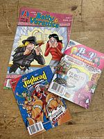 Photo of three Archie Comics: Betty & Veronica #238, B & V Friends Double Digest #230, Jughead and Friends Digest #35 laid out on a wooden surface.