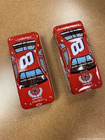 Top view photo showing both red race car shaped tins with large white number 8 decals and Dale Earnhardt signature on roof.