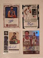 Front side of four NBA rookie autograph cards from 2020-2021 season featuring Ty Jerome, Kenton Martin Jr., Loren Christian Jackson, and Lamar Stevens, displayed in protective sleeves.