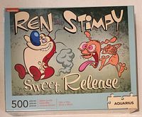 Front of the puzzle box showing Ren and Stimpy characters with the title 'Sweet Release', 500 pieces, and Aquarius branding.