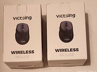 Photo of two boxed Victsing wireless mice with brand and 'WIRELESS MOUSE' text on front.