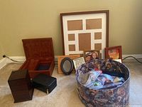 Overview photo showing the wooden boxes, frames, zippered case, and the decorative hat box on the floor.