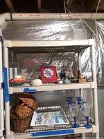 Shelf with various items including wicker baskets and plastic stemware