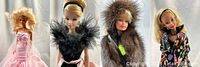 Close-up side view of four Barbie dolls standing in a row in their collectible outfits