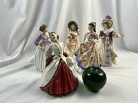 All five figurines grouped with a 3" green apple for scale.