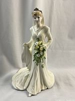 Front view of the figurine showing detailed facial features, bouquet, gown and veil
