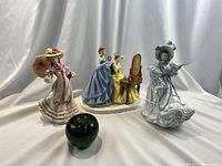 All three figurines with green glass apple size reference