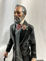 Close-up front view of the upper body showing face, coat, and boutonniere