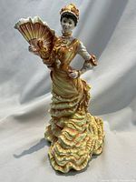 Front view of the Royal Doulton Le Bal figurine showing the full figure, ruffled gown, and fan.