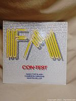 Front side of vinyl record album cover showing 'FM' logo in yellow with text 'CON•TEST' and artists' names below.