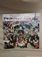Front cover of vinyl record album 'Tinseltown Rebellion' by Frank Zappa with colorful collage image and text.