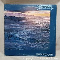 Front cover of Santana Moonflower double live vinyl album showing mountain and cloud landscape under sunset with band name and album title