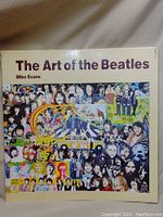 Cover of the book titled 'The Art of the Beatles' featuring a collage of Beatles artwork and photos.