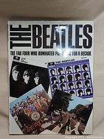 Book cover showing title 'The Beatles' and images of the band and album covers