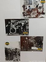 Photo shows several Beatles trading cards mounted on a white board with iconic images of the band in black and white, featuring group and posed shots, each card with The Beatles logo.