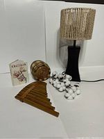 Full view photo of all items in the lot including lamp, pan flute, cotton stems, trinket box, and mini book.
