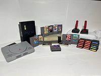 Overview showing PS2, PS1, NES console, controllers, light guns and game cartridges