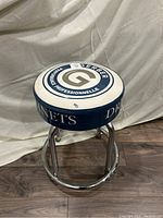 Side view showing the padded stool with Gerber branding and chrome metal legs.