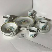 Full view of the dish set showing bowls, plates, cups, and saucers with floral design.