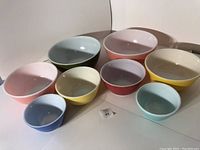 All eight vintage PYREX nesting bowls arranged showing colors and condition