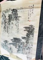 Full view of Asian traditional ink wash painting on rice paper depicting mountain rain forest landscape with trees and mist.