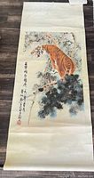 Full view of the scroll artwork showing Bengal tiger on a tree limb with calligraphy on the left side.