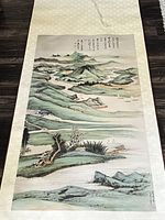 Full view of the mountain and river landscape scroll with calligraphy and boats.